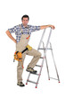 Laborer leaning on a ladder isolated on white background