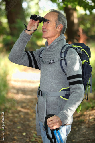 Photo: Hiker looking through binoculars Hiker looking through binoculars