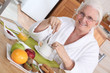 Elderly woman having breakfast