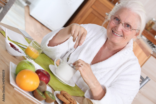 Photo: Elderly woman having breakfast Elderly woman having breakfast