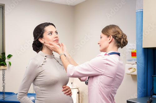 Photo: Doctor endocrinologist checking thyroid pregnant Doctor endocrinologist checking thyroid pregnant