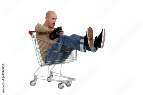 Photo: Man driving a shopping trolley Man driving a shopping trolley