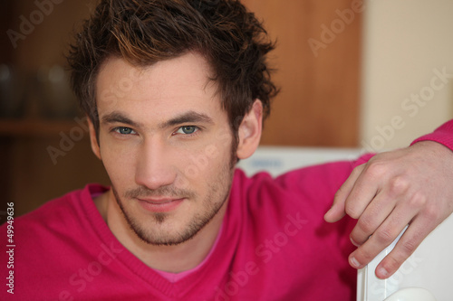 Photo: Casual young man relaxing at home Casual young man relaxing at home