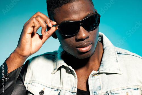 Photo: Cool urban stylish black american man. Fashion studio shot. Cool urban stylish black american man. Fashion studio shot.