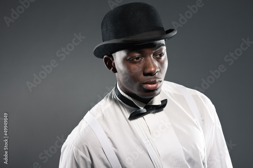 Photo: Vintage black american man in suit with hat. Fashion studio shot Vintage black american man in suit with hat. Fashion studio shot