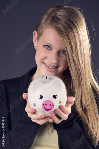Photo: Blond smiling Teenie saving her Money Blond smiling Teenie saving her Money