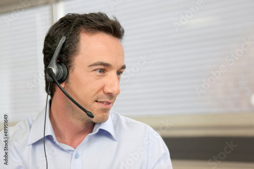 Photo: Office worker with headset Office worker with headset