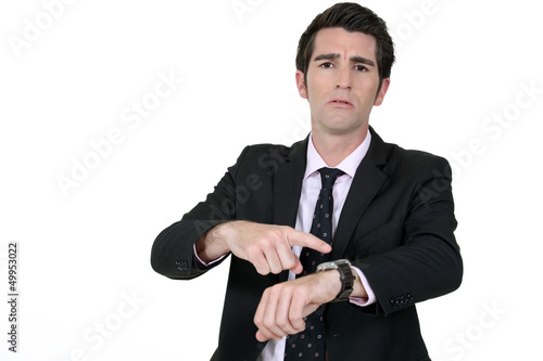 Photo: Businessman pointing at his watch Businessman pointing at his watch