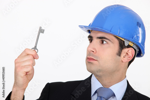 Photo: Man staring at a key Man staring at a key