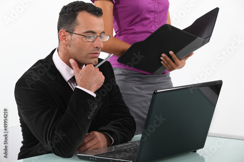 Photo: A boss and his secretary at work. A boss and his secretary at work.