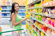 Woman buys potato chips in the store