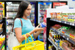A woman buys tinned meat