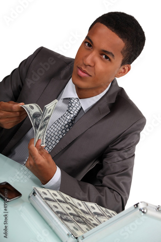 Photo: Businessman with briefcase full of money Businessman with briefcase full of money