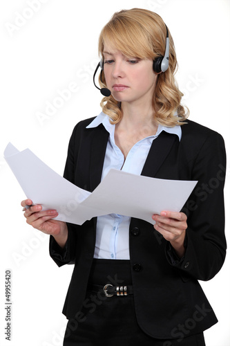 Photo: A blond businesswoman with a headset on. A blond businesswoman with a headset on.