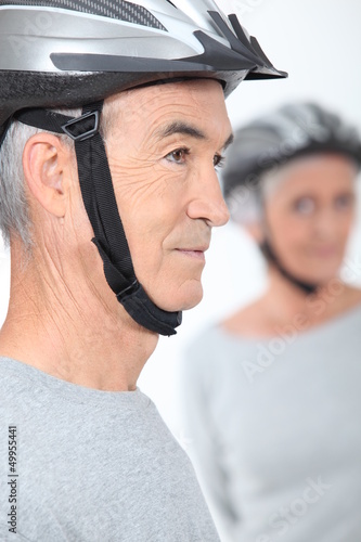 Photo: Elderly couple with cycle helmets Elderly couple with cycle helmets