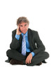 Critical manager sitting on floor