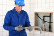 Photo: Artisan fitting two parts of pipe together Artisan fitting two parts of pipe together