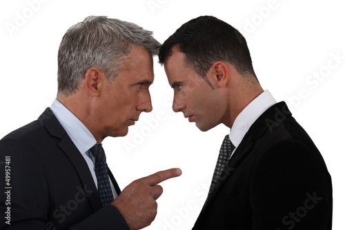 Photo: Younger and older businessmen head to head Younger and older businessmen head to head