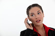 woman with cell phone straining her ears