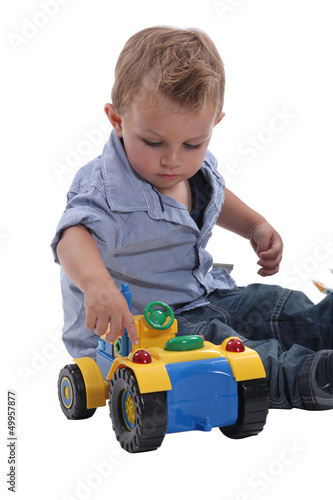 Photo: Young boy playing with a toy car Young boy playing with a toy car