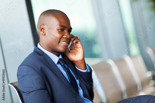 Photo: african american talking on cell phone at airport african american talking on cell phone at airport