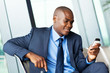 handsome african american businessman using smart phone emailing