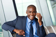 Photo: african business traveller talking on cellphone in airport african business traveller talking on cellphone in airport