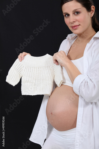 Photo: Pregnant woman with knitted jumper Pregnant woman with knitted jumper