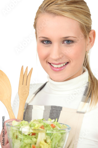 Photo: Blond girl eating green salad Blond girl eating green salad