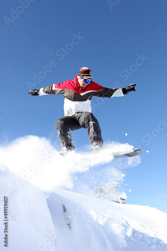 Photo: A snowboarder gliding through the air A snowboarder gliding through the air