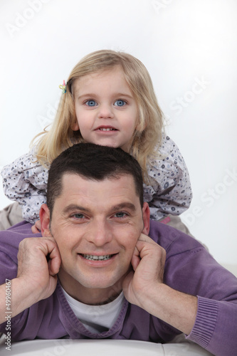 Photo: Father and daughter laying on bed Father and daughter laying on bed