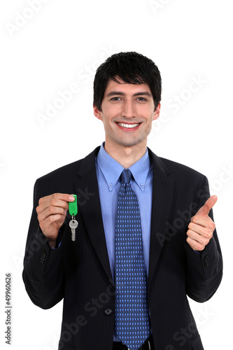 Photo: Car salesmen holding keys Car salesmen holding keys