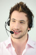 Attractive man speaking into a headset