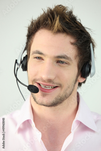 Photo: Attractive man speaking into a headset Attractive man speaking into a headset