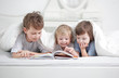 Photo: three boy read book indoors three boy read book indoors