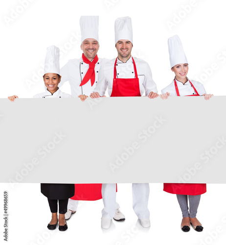 Photo: Group of chefs presenting empty banner Group of chefs presenting empty banner