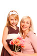 Little girl and woman with flowers on a white background