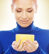 Portrait of a happy woman in a blue sweater holding a cup of tea