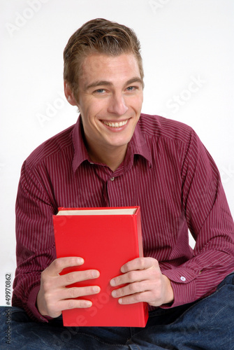 Photo: Hombre joven leyendo un libro.Estudiante universitario. Hombre joven leyendo un libro.Estudiante universitario.