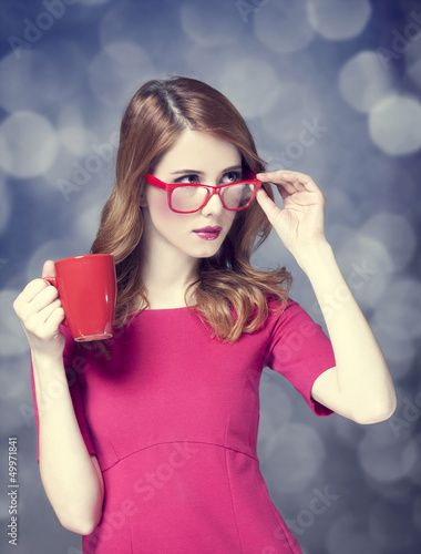 Photo: Redhead girl with red cup. Redhead girl with red cup.