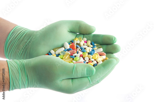 Photo: Hand with pills. Many colorful pills on two hands Hand with pills. Many colorful pills on two hands