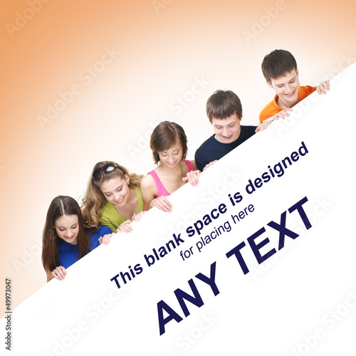 Photo: A group of teenagers holding a white blank banner with text A group of teenagers holding a white blank banner with text