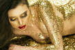 Foto: Magic Girl Portrait in Gold. Golden Makeup Magic Girl Portrait in Gold. Golden Makeup