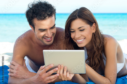 Photo: Happy Couple With Digital Tablet Happy Couple With Digital Tablet