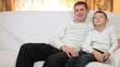 Father and son watching TV together