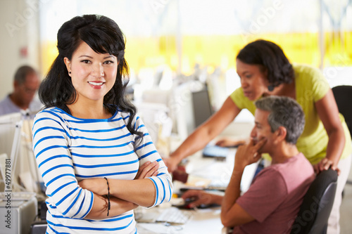 Photo: Portrait Of Woman Standing In Busy Creative Office Portrait Of Woman Standing In Busy Creative Office