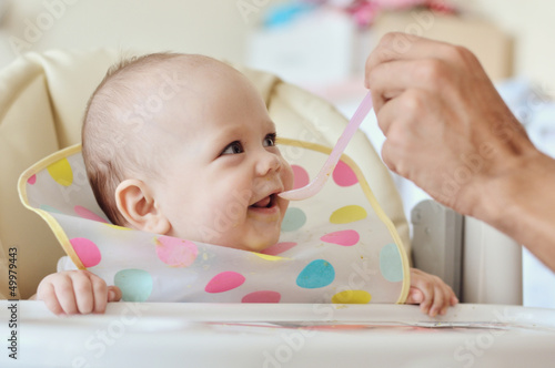 Photo: father feeding baby father feeding baby