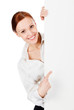Happy smiling young business woman with a blank signboard