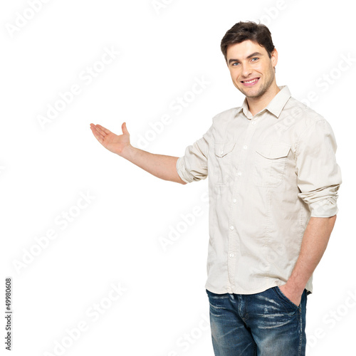 Photo: Young man shows something isolated on white Young man shows something isolated on white