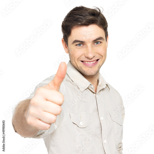Photo: Young happy man with thumbs up sign in casuals Young happy man with thumbs up sign in casuals